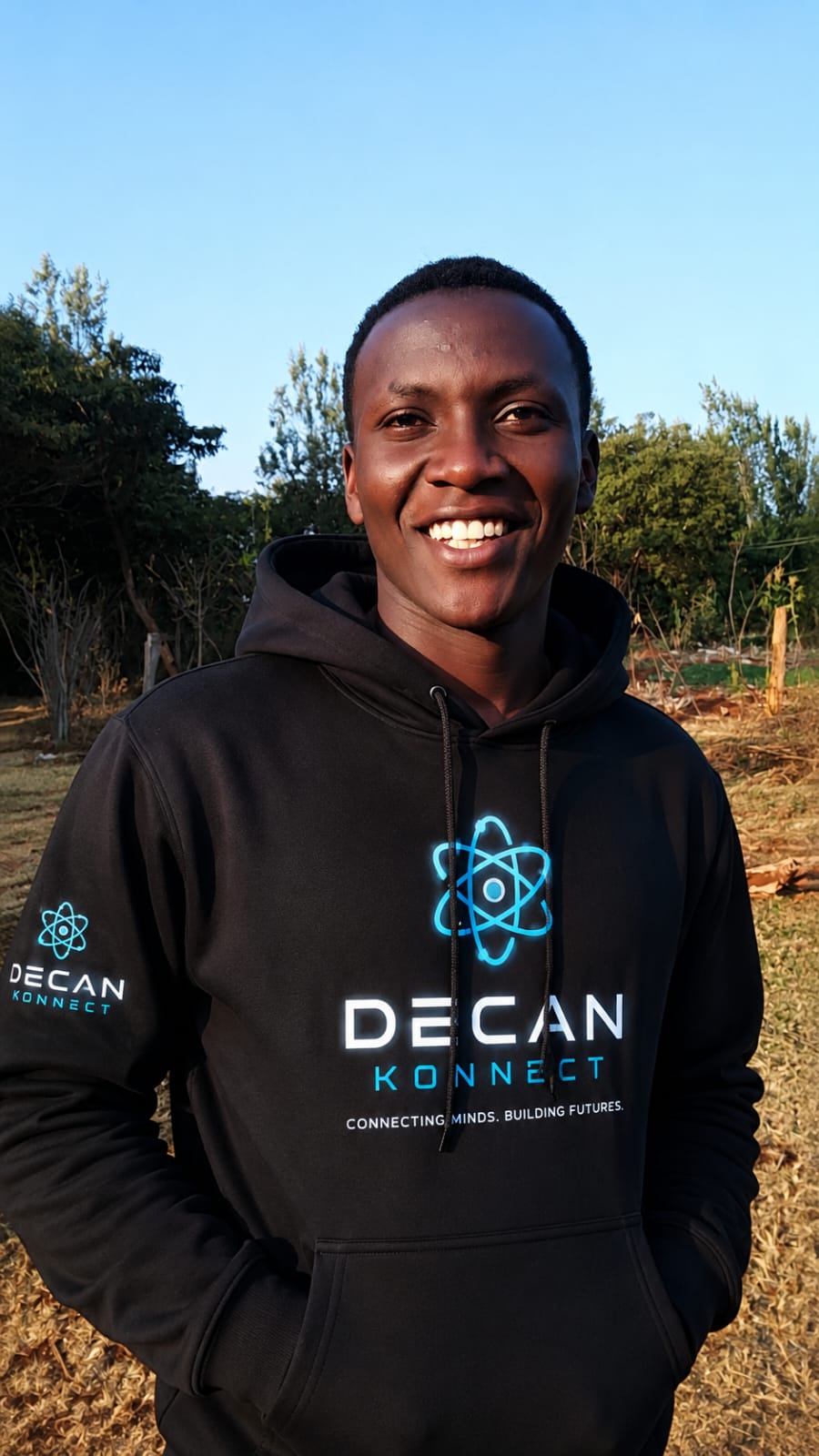 Lenny Muriuki wearing a Decan Konnect hoodie outdoors